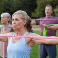 Seniors caring for their bodies. Older adults doing arm exercises with resistance bands