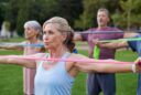 Seniors caring for their bodies. Older adults doing arm exercises with resistance bands