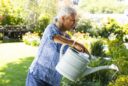 senior woman watering spring flowers