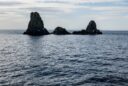 The cliffs of Cyclops (Faraglioni dei Ciclopi) in the sea near Aci Trezza town, Sicily, Italy. Large stones are believed to be thrown at Odysseus